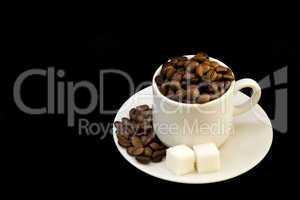 white cup with coffee beans and shugar