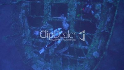 Technical diver exploring deep shipwreck