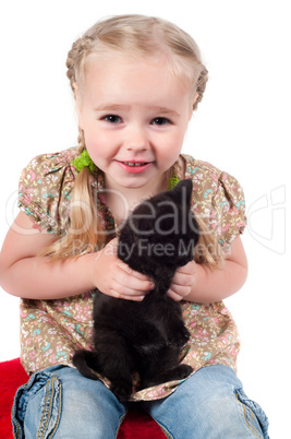 Little girl playing with kitten