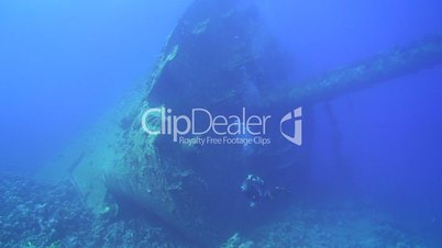 Scuba diver exploring the bow section Red Sea shipwreck