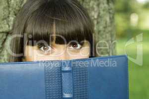 Female in a park with a notebook