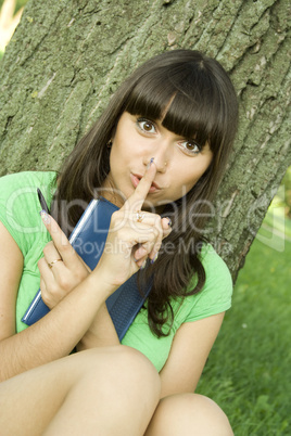 Female in a park with a notebook
