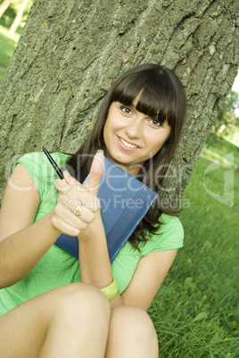 Female in a park with a notebook