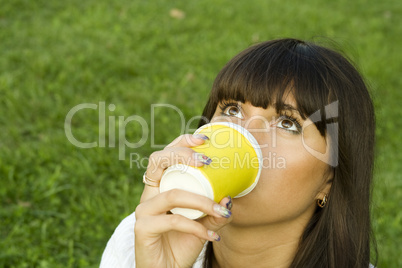 Female in a park drinking coffee