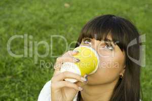 Female in a park drinking coffee