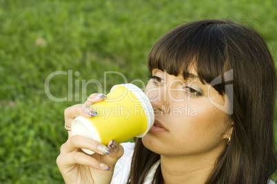 Female in a park drinking coffee