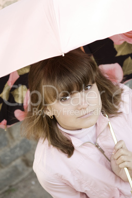 Girl in pink under the umbrella