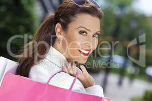 Beautiful Happy Woman With Pink and White Shopping Bags