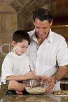 Father and Son In Kitchen Cooking Baking Cookies