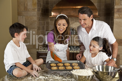 Attractive Family Baking and Eating Cookies In A Kitchen