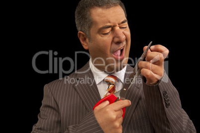 Businessman cutting nails with huge scisors