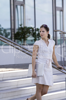 business lady with laptop on stairs