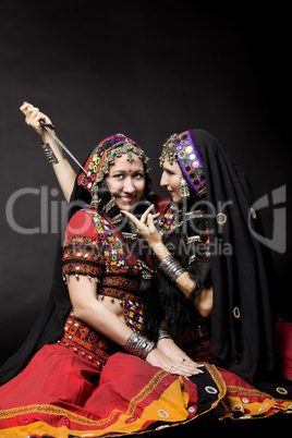 two young woman play with knife