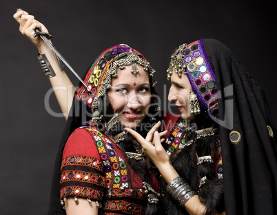 two young woman play with knife