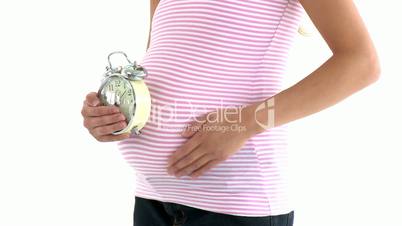 schwangere Frau mit Wecker