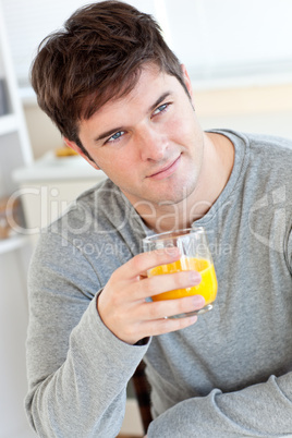 man drinking orange juice