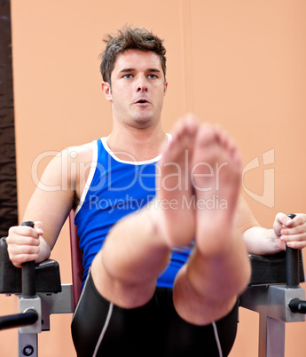 Muscular young man exercising