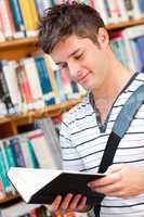 male student reading a book