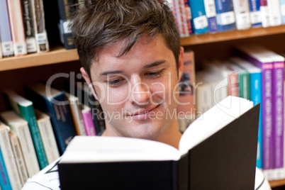 male student reading a book