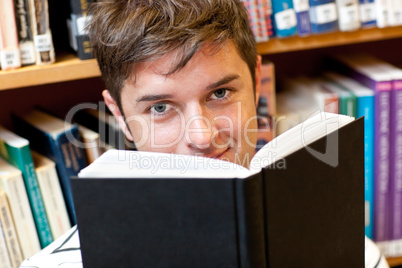 male student reading a book