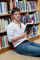 male student reading a book