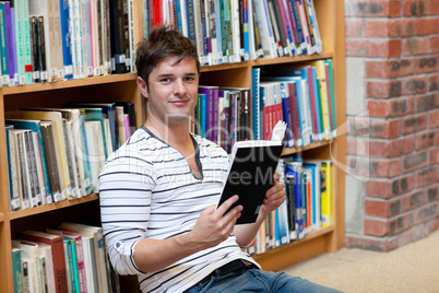 male student reading a book