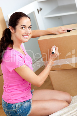 woman writing on a box