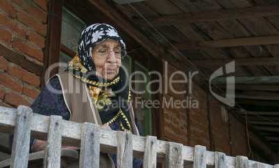 Senior woman watching from balcony