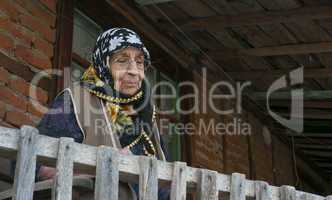 Senior woman watching from balcony