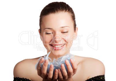 Beautiful girl with feathers in hands