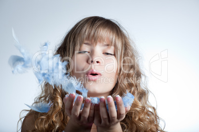 Beautiful girl with feathers in hands