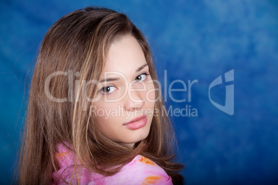 Young woman posing on a blue background