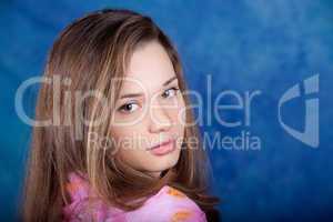 Young woman posing on a blue background