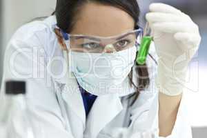 Female Laboratory Scientist or Doctor with Green Liquid Test Tub