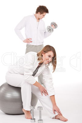 Fitness - Young couple training with weights and ball