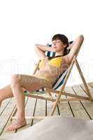 Beach - Beautiful woman sunbathing in bikini on deckchair