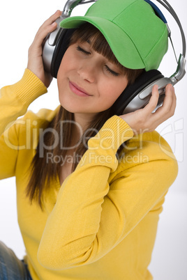 Happy female teenager enjoy music