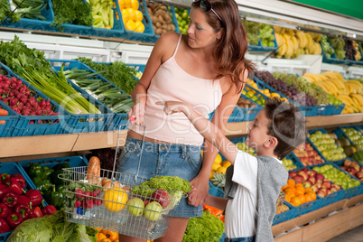 Grocery store shopping - Woman with child buying vegetable