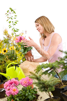 Gardening - Happy woman holding flower pot