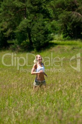 Young woman jogging in a meadow