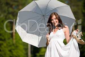 Happy romantic woman with parasol in sunlight