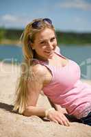 Beautiful blond woman lying on sunny beach