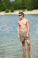 Man enjoy sun at seashore standing in water