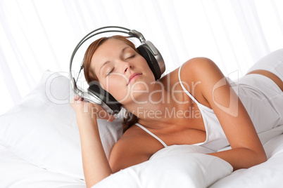 Young woman in white with headphones