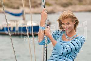 Blond young woman on sailing boat