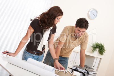 Young man and woman working at architect office