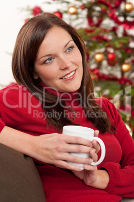 Brown hair woman relaxing in front of Christmas tree