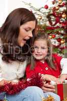 Mother with child opening present