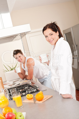 Happy couple having breakfast in the kitchen