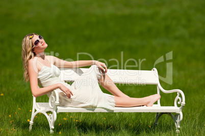 Spring and summer - Young woman relaxing in meadow